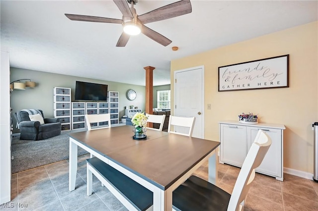 dining area featuring a ceiling fan, light tile patterned flooring, and decorative columns
