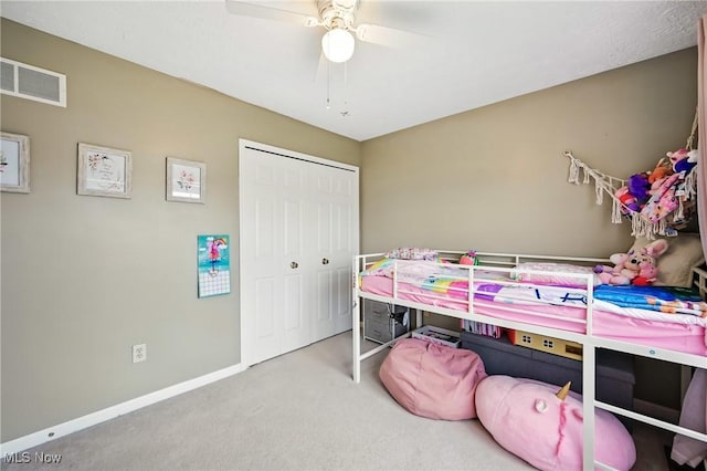 bedroom featuring carpet, a closet, visible vents, baseboards, and ceiling fan