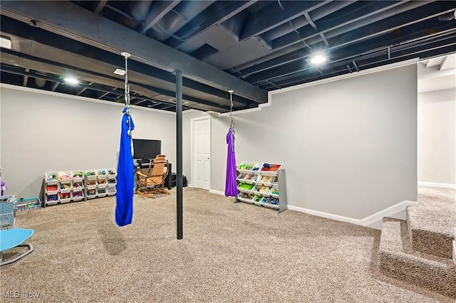 finished basement featuring baseboards and carpet floors