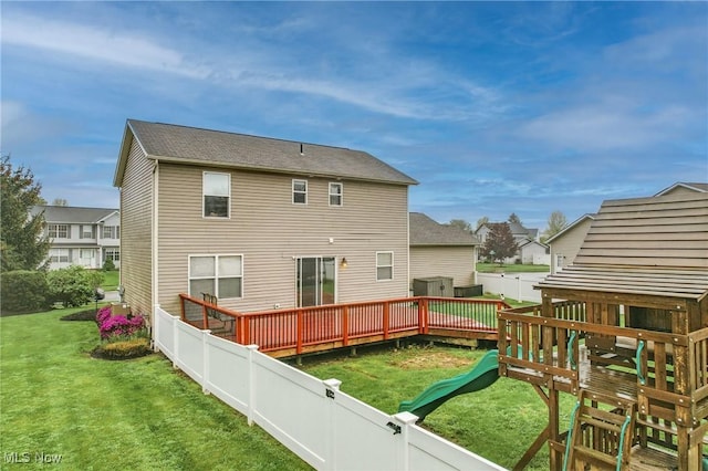back of house with a playground, a residential view, a lawn, and a fenced backyard