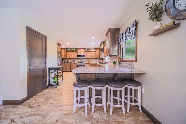 4661 Sugar Grove Rd, Cambridge, OH 43725 - kitchen featuring baseboards, stainless steel appliances, a peninsula, and a kitchen bar