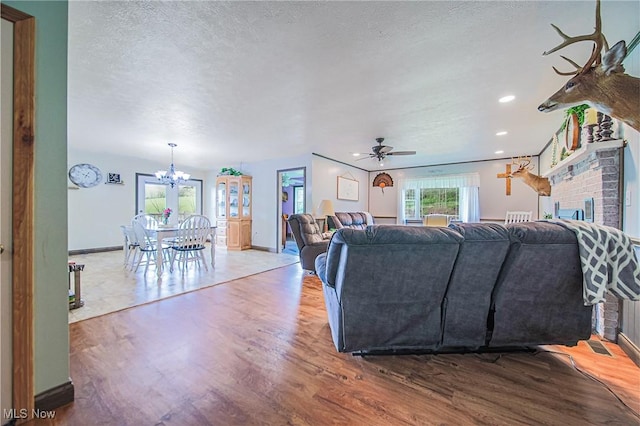 4661 Sugar Grove Rd, Cambridge, OH 43725 - living room featuring ceiling fan with notable chandelier, wood finished floors, a textured ceiling, recessed lighting, and baseboards