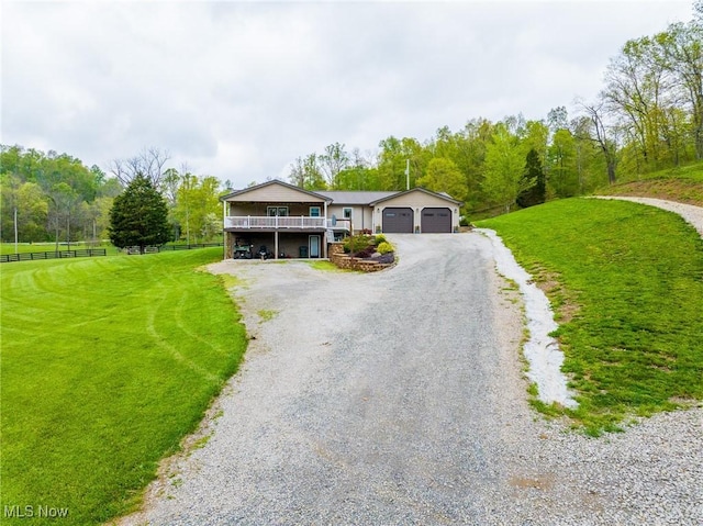 4661 Sugar Grove Rd, Cambridge, OH 43725 - view of front of home featuring driveway, a front lawn, fence, and an attached garage