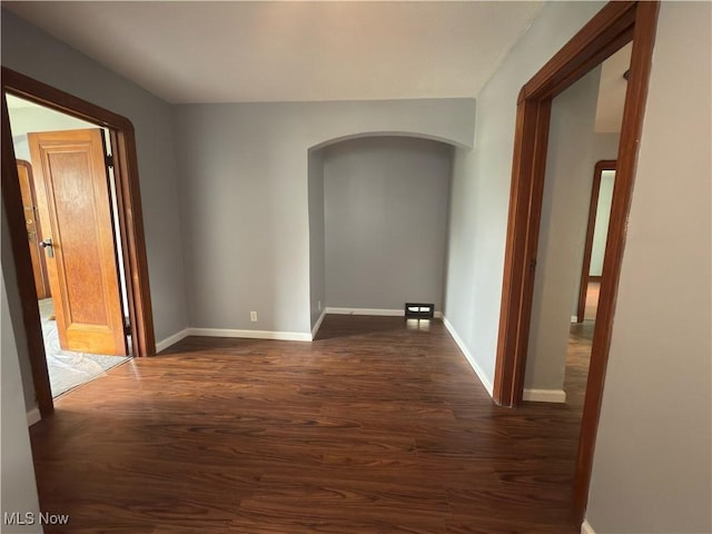 131 Blake St, Elyria, OH 44035 - hall with dark wood-style flooring, arched walkways, and baseboards