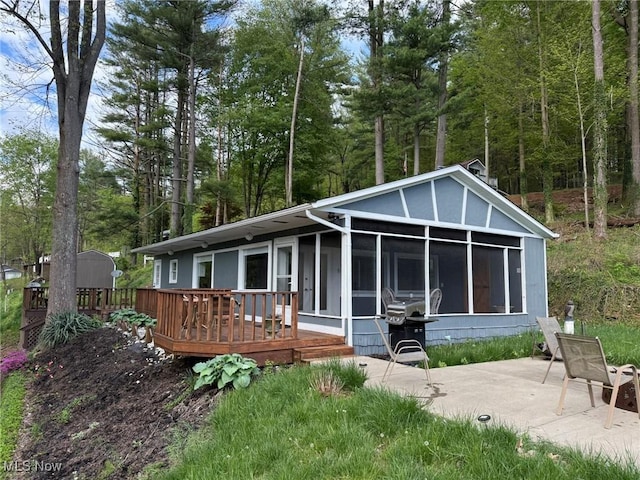 37080 Penrose Ln, Cadiz, OH 43907 - back of property featuring a sunroom, a wooden deck, and a patio area