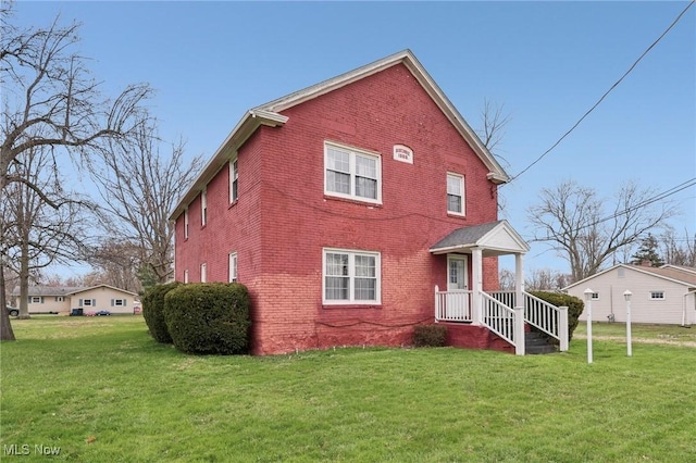 2419 Carpenter Rd, Ashtabula, OH 44004 - view of front of house with brick siding and a front yard