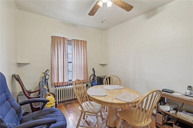 2419 Carpenter Rd, Ashtabula, OH 44004 - dining room with a ceiling fan, radiator, and wood finished floors