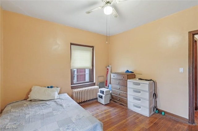 2419 Carpenter Rd, Ashtabula, OH 44004 - bedroom featuring a ceiling fan, radiator, baseboards, and wood finished floors
