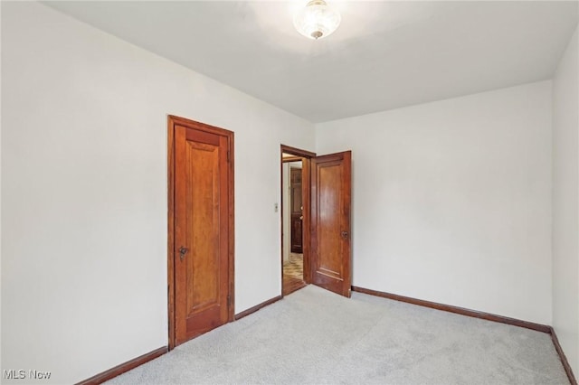2419 Carpenter Rd, Ashtabula, OH 44004 - spare room featuring baseboards and light carpet