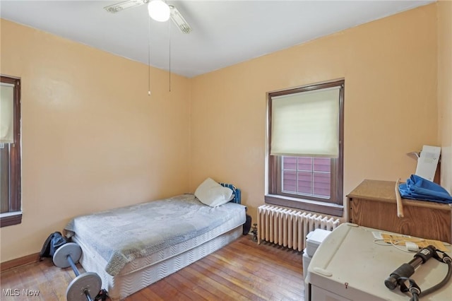 2419 Carpenter Rd, Ashtabula, OH 44004 - bedroom featuring ceiling fan, radiator, and light wood-type flooring