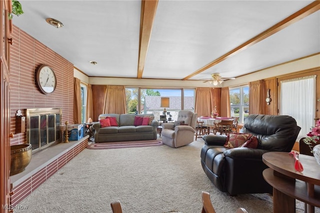 carpeted living area featuring ceiling fan and a brick fireplace