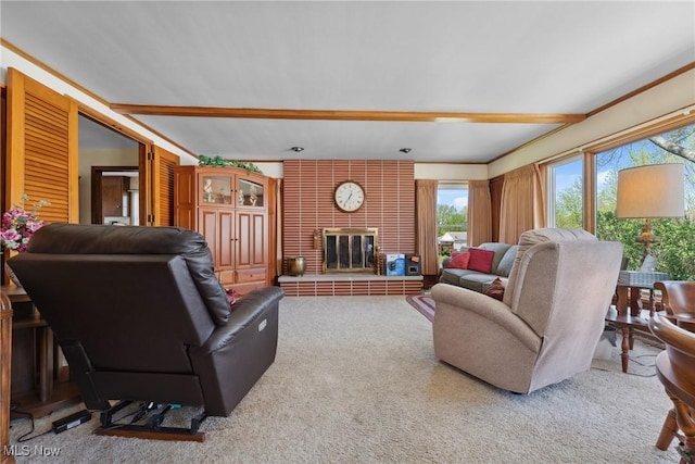 carpeted living room with a brick fireplace