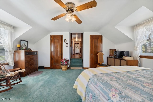 carpeted bedroom featuring vaulted ceiling, baseboards, and a ceiling fan