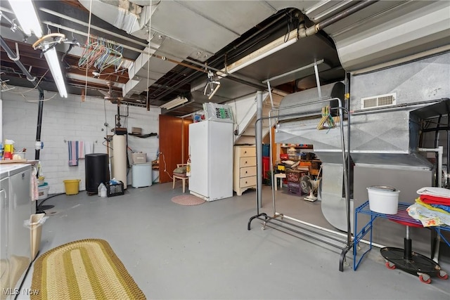 unfinished basement featuring washing machine and dryer and visible vents