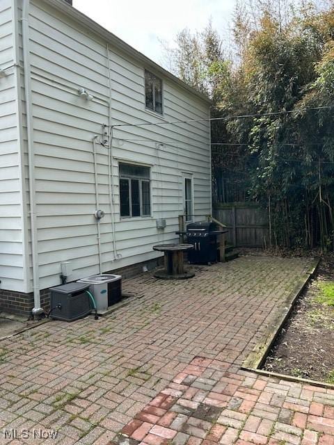 back of property with a patio, fence, and central AC