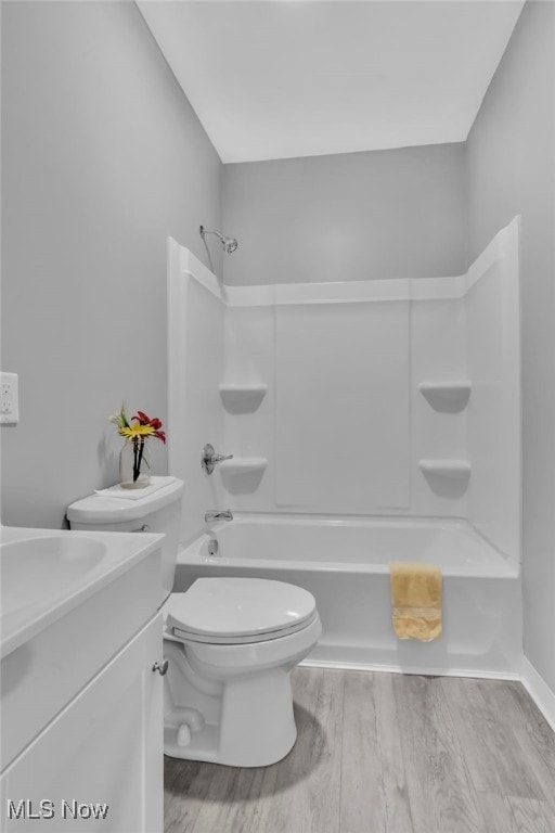 1250 Alamo Rd SE, Carrollton, OH 44615 - bathroom featuring toilet, bathing tub / shower combination, wood finished floors, and vanity