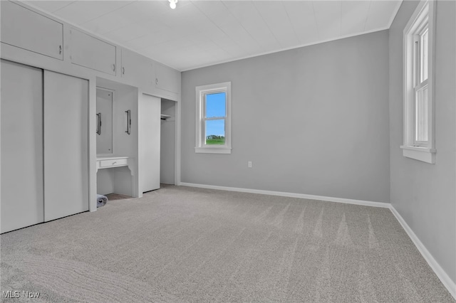 1250 Alamo Rd SE, Carrollton, OH 44615 - unfurnished bedroom with carpet floors, baseboards, and multiple closets