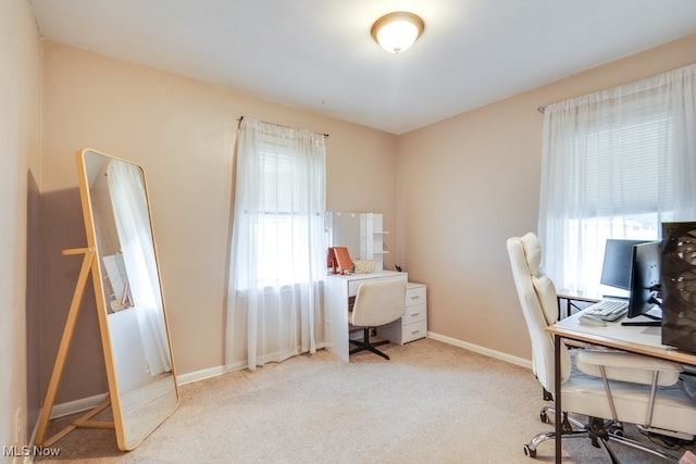 carpeted office space with baseboards