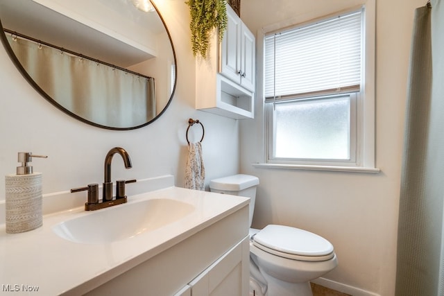 full bathroom with toilet and vanity