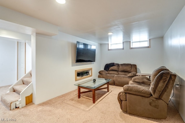 carpeted living room with stairs