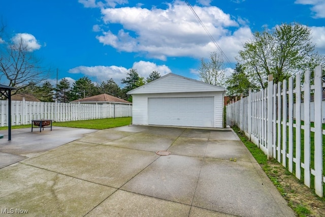 detached garage featuring fence
