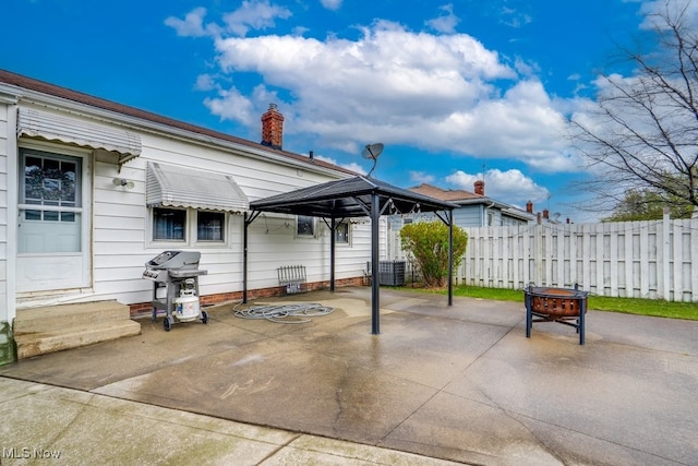 view of patio / terrace with a gazebo, a fire pit, grilling area, and fence