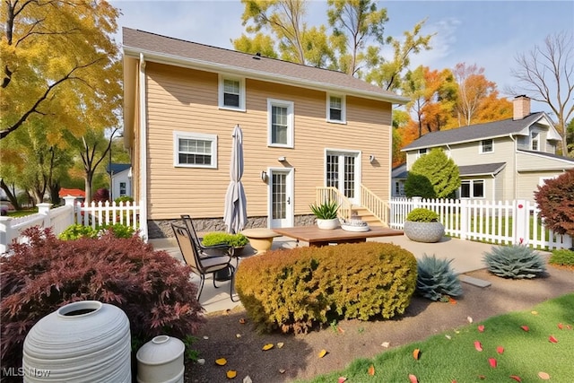 back of house featuring a patio area and fence