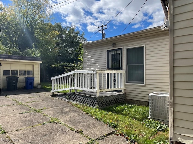 view of home's exterior with central AC unit and a wooden deck
