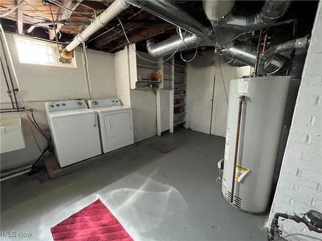 basement featuring water heater and independent washer and dryer
