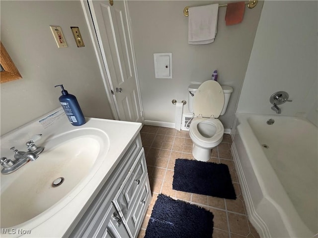 bathroom with toilet, tile patterned flooring, and vanity