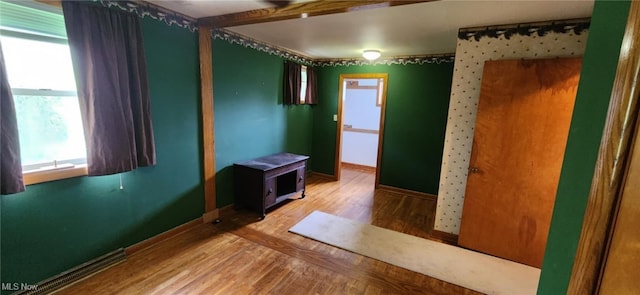 interior space featuring wood finished floors and baseboards