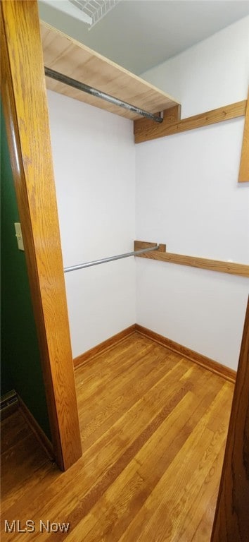 spacious closet featuring wood finished floors