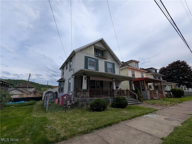 1510 Chester Ave, Wellsville, OH 43968 - view of front of home with covered porch, fence, and a front lawn