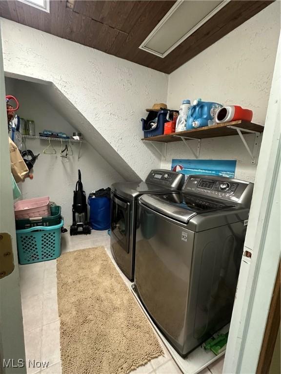 13978 Sprucevale Rd, East Liverpool, OH 43920 - clothes washing area with washing machine and clothes dryer, laundry area, a textured wall, and tile patterned flooring