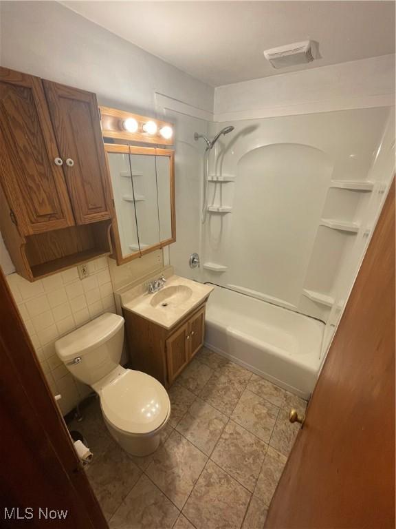 full bathroom featuring shower / bathtub combination, toilet, visible vents, tile patterned flooring, and vanity