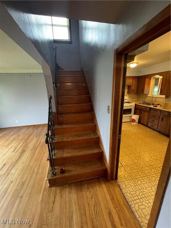 staircase with wood finished floors