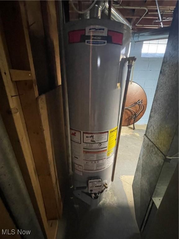 utility room featuring gas water heater