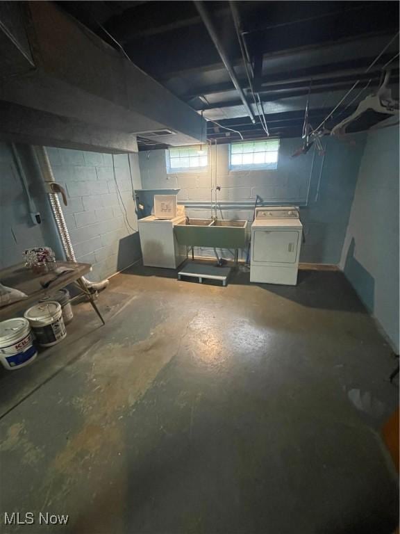 basement featuring washer / dryer and a sink