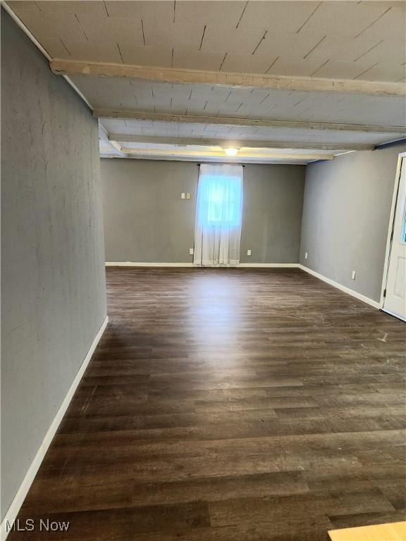 below grade area featuring baseboards and wood finished floors