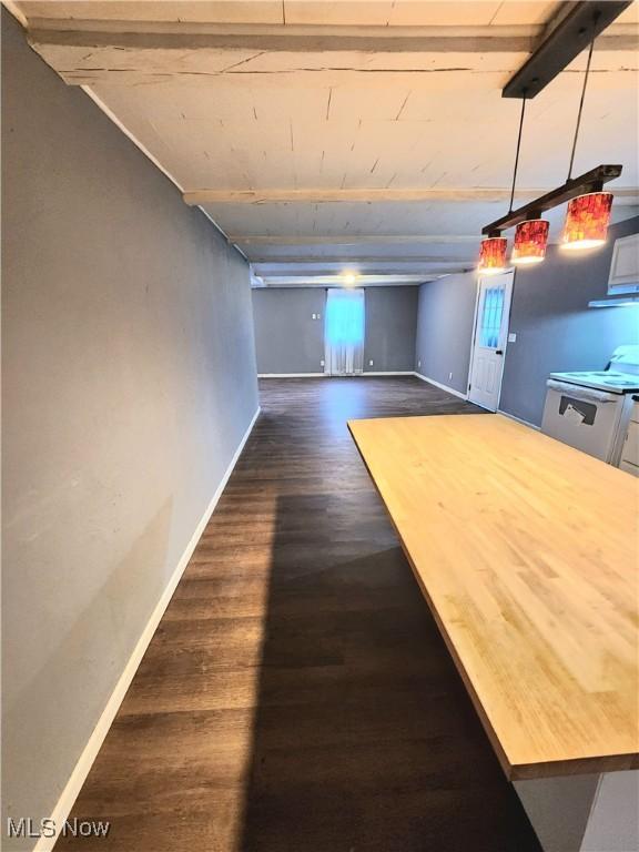 interior space with baseboards and dark wood-type flooring