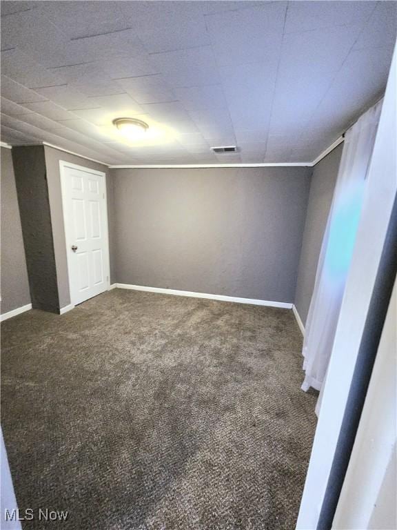 interior space featuring carpet flooring, visible vents, and baseboards