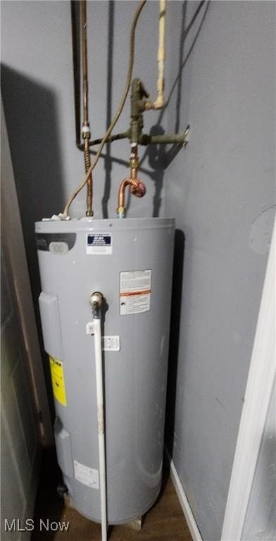 utility room featuring water heater