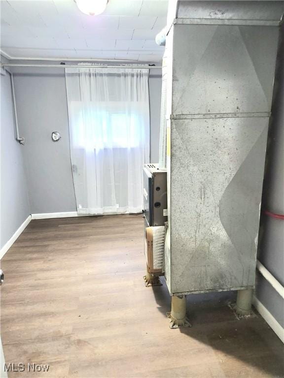 interior space featuring baseboards and wood finished floors