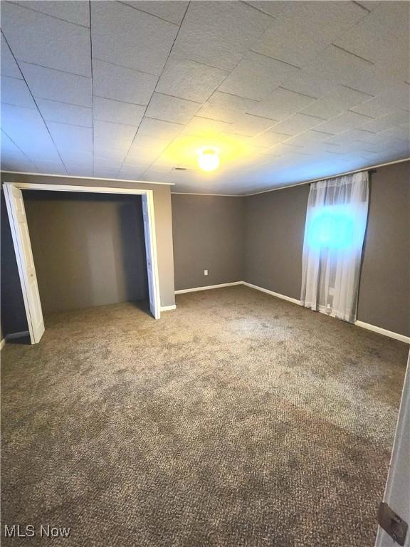 unfurnished bedroom with baseboards and carpet flooring