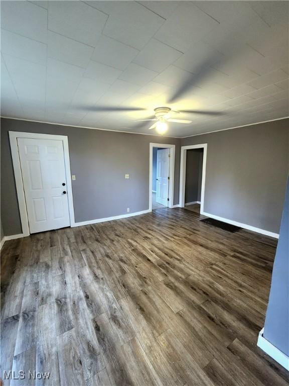 unfurnished room featuring baseboards, a ceiling fan, and wood finished floors