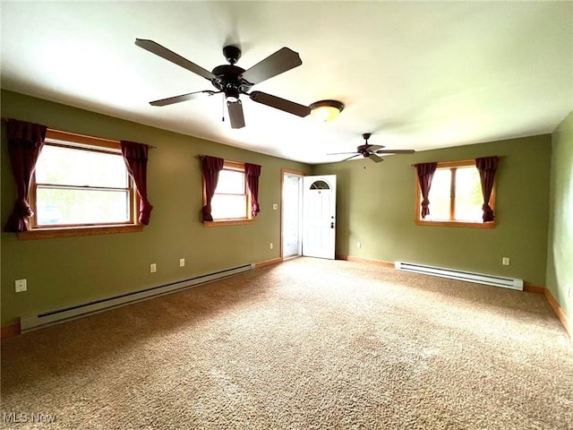 spare room featuring plenty of natural light, baseboard heating, and ceiling fan