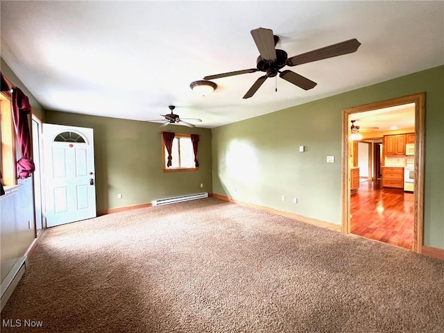 spare room featuring a ceiling fan, baseboards, baseboard heating, and carpet floors