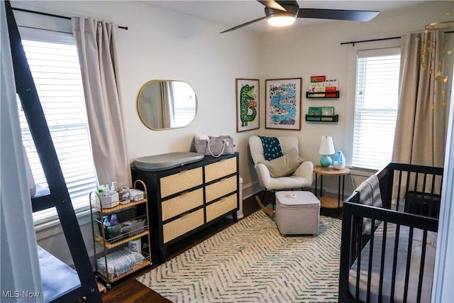 bedroom with wood finished floors, baseboards, and ceiling fan