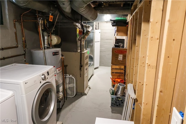 unfinished below grade area featuring washer and dryer, water heater, and heating unit