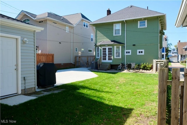 back of house with a yard, french doors, fence, a patio area, and entry steps